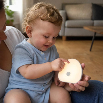 Veilleuse bruit blanc dans mains bebe